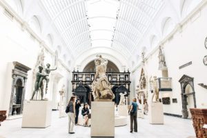 Visitors view sculptures at a museum