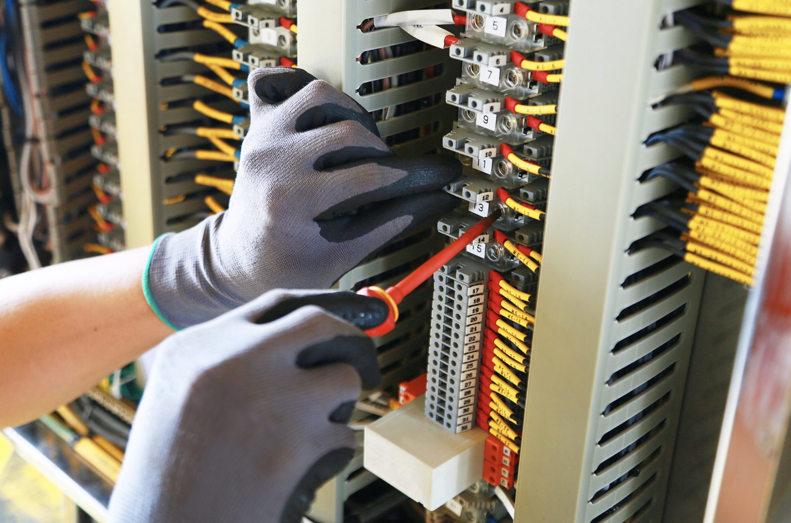 Hands working on an alarm system