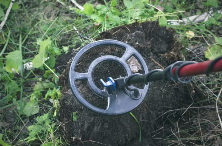 Metal detector goes over a plot of soil